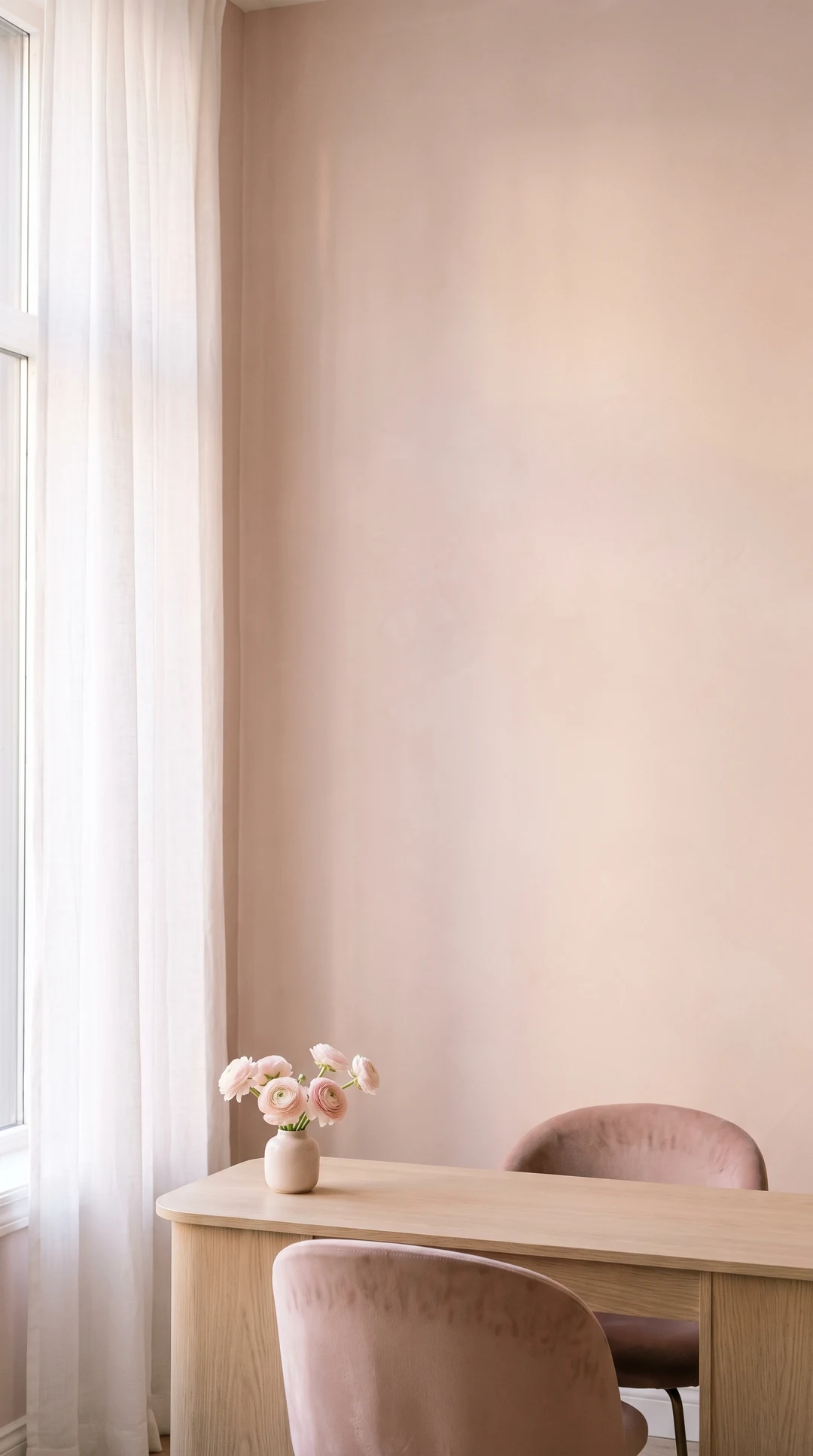 The studio: an oak manicure table by a tall curtained window